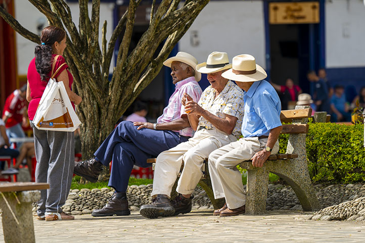 Men talking in the central park of Jardín Antioquia