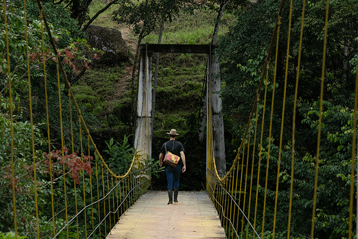 Tourist on suspension bridge over river in Florencia Caquetá